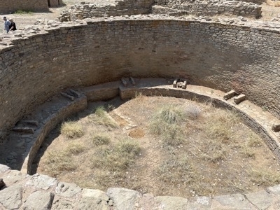 Ancient Indigenous engineered water facility with people in upper right hand corner for scale at Aztec Ruins National Monument in Aztec New Mexico
