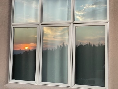 Sunset reflected in window of house outside of Santa Fe New Mexico
