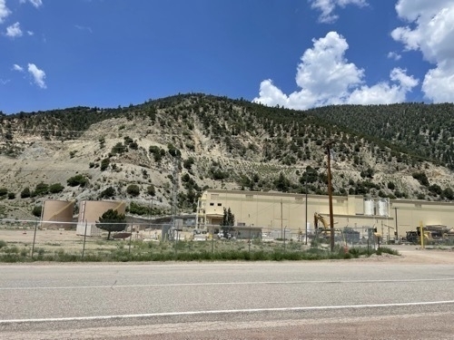 Industrial development in front of forested mountain along Enchanted Circle in New Mexico 