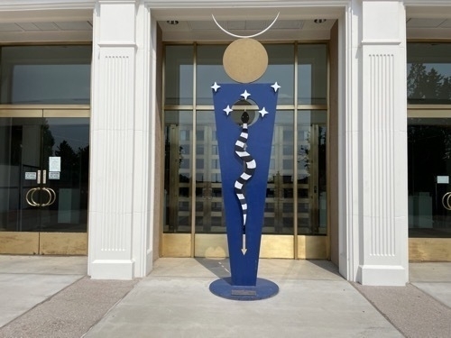 Blue metal sculpture in front of New Mexico Caputol building